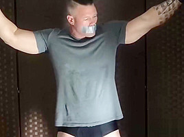 Bound muscular dude endures tickling from a mature deviant