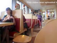 Brunette MILF flashing her jugs in a restaurant