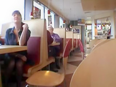 Brunette MILF flashing her jugs in a restaurant