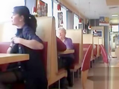 Brunette MILF flashing her jugs in a restaurant