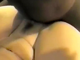 Brunette milf sucks a black cock while getting fucked from behind