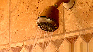 Busty brunette babe in shower jerks off guy