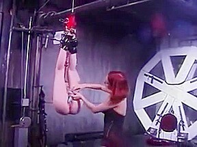 Curvy redhead shackled by lingere dominatrix