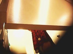 Girl in a dressing room puts on tiny top and candid shorts