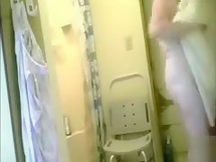 Granny dries her body after a shower