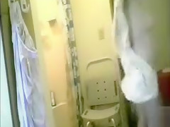 Granny dries her body after a shower