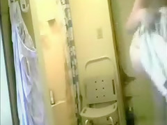 Granny dries her body after a shower