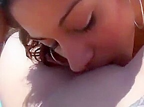 Horny female coeds swim topless and play with each other in pool