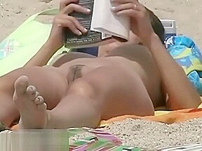 Hot body babe lying down on the beach surprised by a