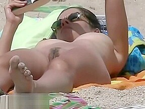 Hot body babe lying down on the beach surprised by a