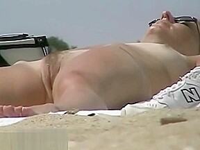 Hot body babe lying down on the beach surprised by a