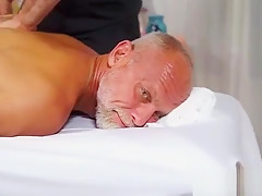Hunky masseur blowing older guys cock