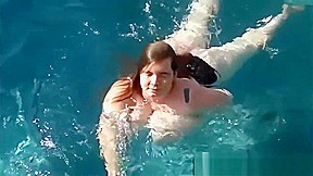 Lexxi Luxe swims half nude in a pool 