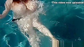 Lexxi Luxe swims half nude in a pool 