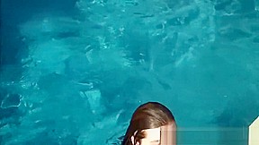 Lexxi Luxe swims half nude in a pool 