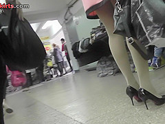 Long-legged brunette shows g-string in candid upskirts