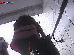 Long-legged brunette shows g-string in candid upskirts