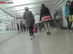 Long-legged brunette shows g-string in candid upskirts