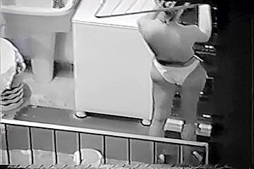 Nude Latin chick spied doing her laundry thru the window