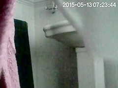 Partner on in bathroom getting undressed to wash