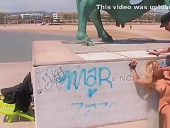 Shackled blonde in underwear in public