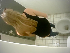 Slim long-haired brunette takes a quick whiz in the restroom