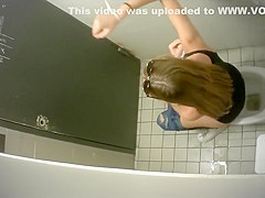 Slim long-haired brunette takes a quick whiz in the restroom