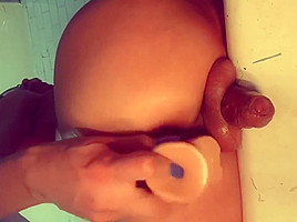 TS shows off her cock from the back
