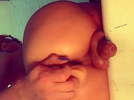 TS shows off her cock from the back