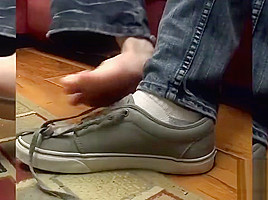 Tattooed twink gets a footjob before getting to blow cock