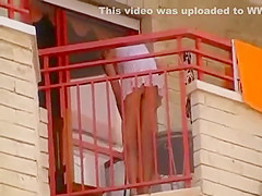 Upskirt of a neighbor at a balcony