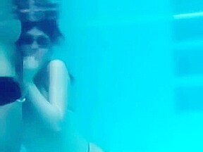 White Asics swimsuit underwater play